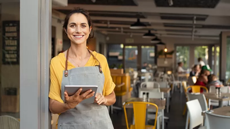 Woman holding a tablet in an open work environment