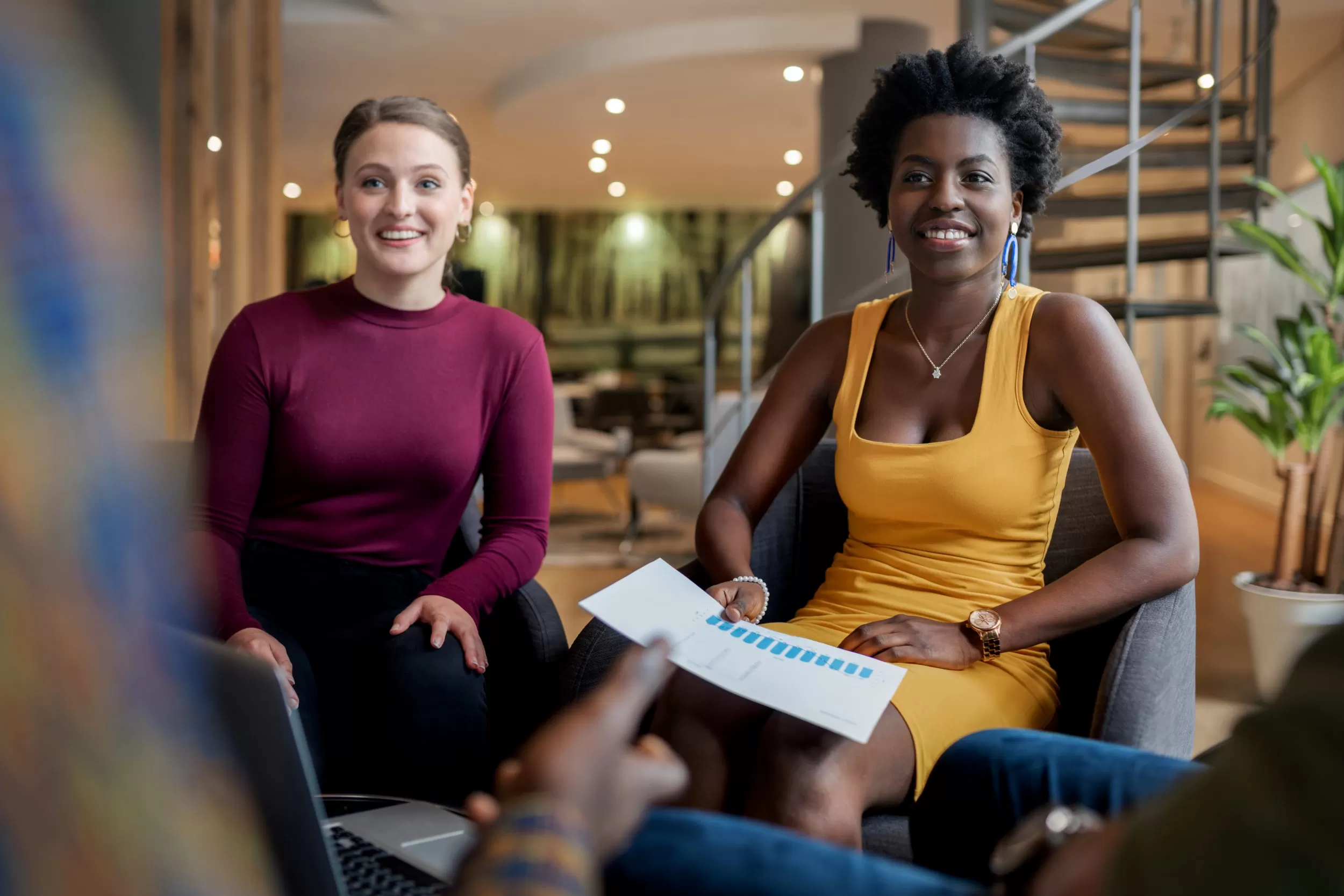 Two women collaborating on a project in a casual work environment